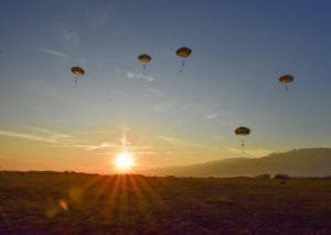 Parachute drop at dawn.