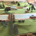 Now the Borg advance is in full flow and their main troops are pouring over the bridge, led by their pale blue coated Jäger. In the distance, the Grenouissian chasseurs à cheval are threatening the Borg line, so it turns obliquely to face.