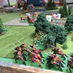 The Grenouissian chasseurs à cheval moving past their à pied colleagues in the woods. Here you can see how the light infantry have managed to send part of their unit forward into the eastern copse.