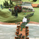 It's clear that the bridge builders have done a great job and despite accurate fire from the Grenouissian guns, a constant stream of units is crossing the Carillon. In the north, Jäger are threatening to outflank the Grenouissians, who shuffle round in the trees to pepper them in the flank. The Grenouissian fusiliers facing the farm must soon make a desperate choice.