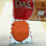 Placing a sheet of DAS clay into the mould.